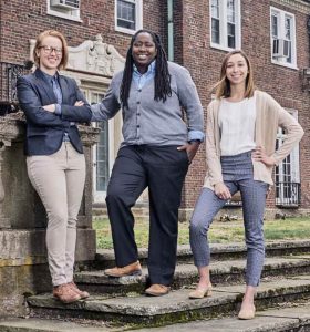 Thanithia Billings, center, passes the baton to the new co-editors, Kelsey Gasseling, left, and Caitlin Toto.