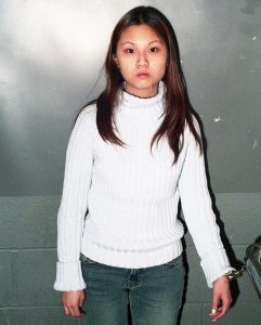 Choy at 17, chained and in custody.