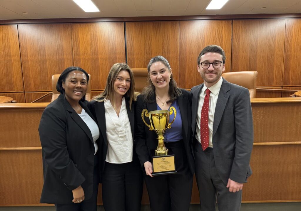 mock trial team 2025 at quinnipiac holding 1st place trophy